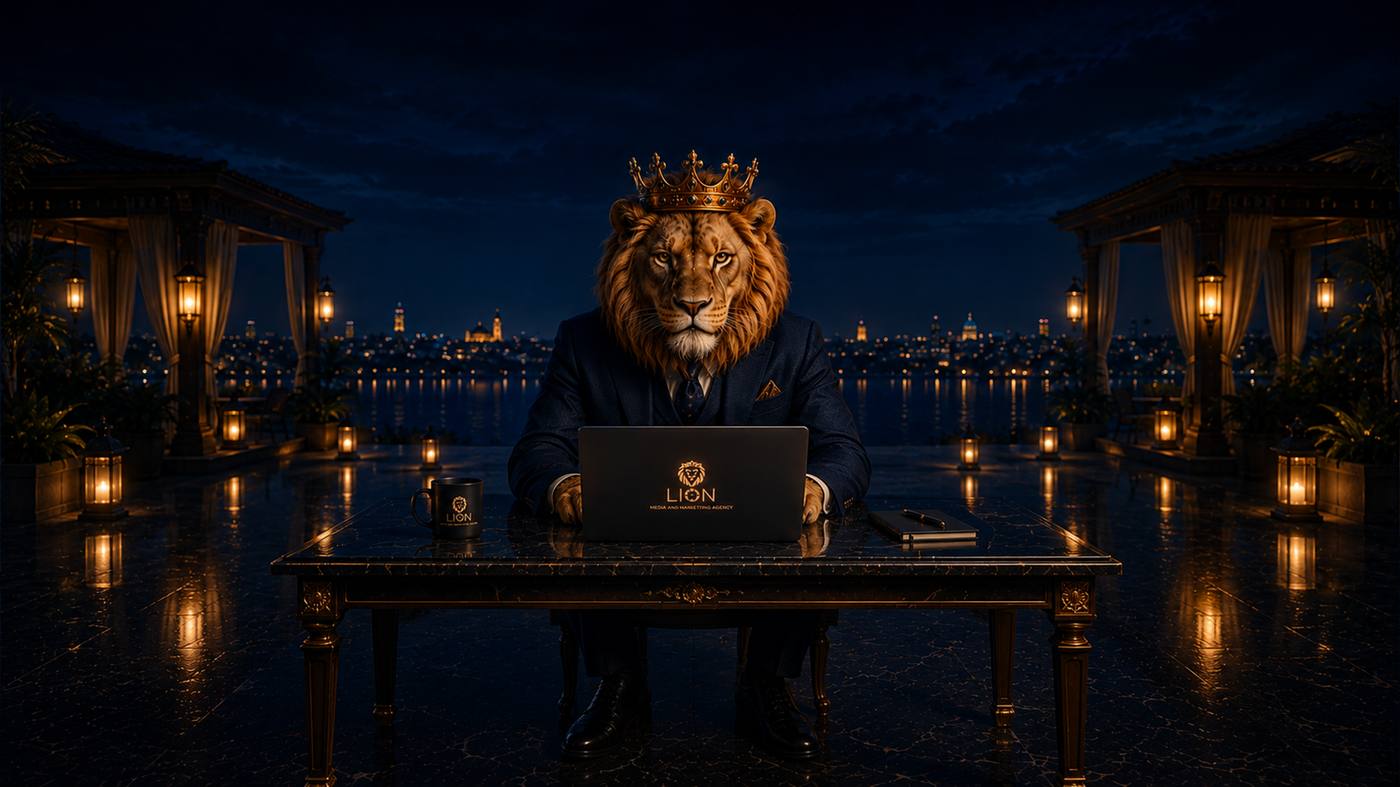 A crowned lion working on a laptop bearing the Lion logo